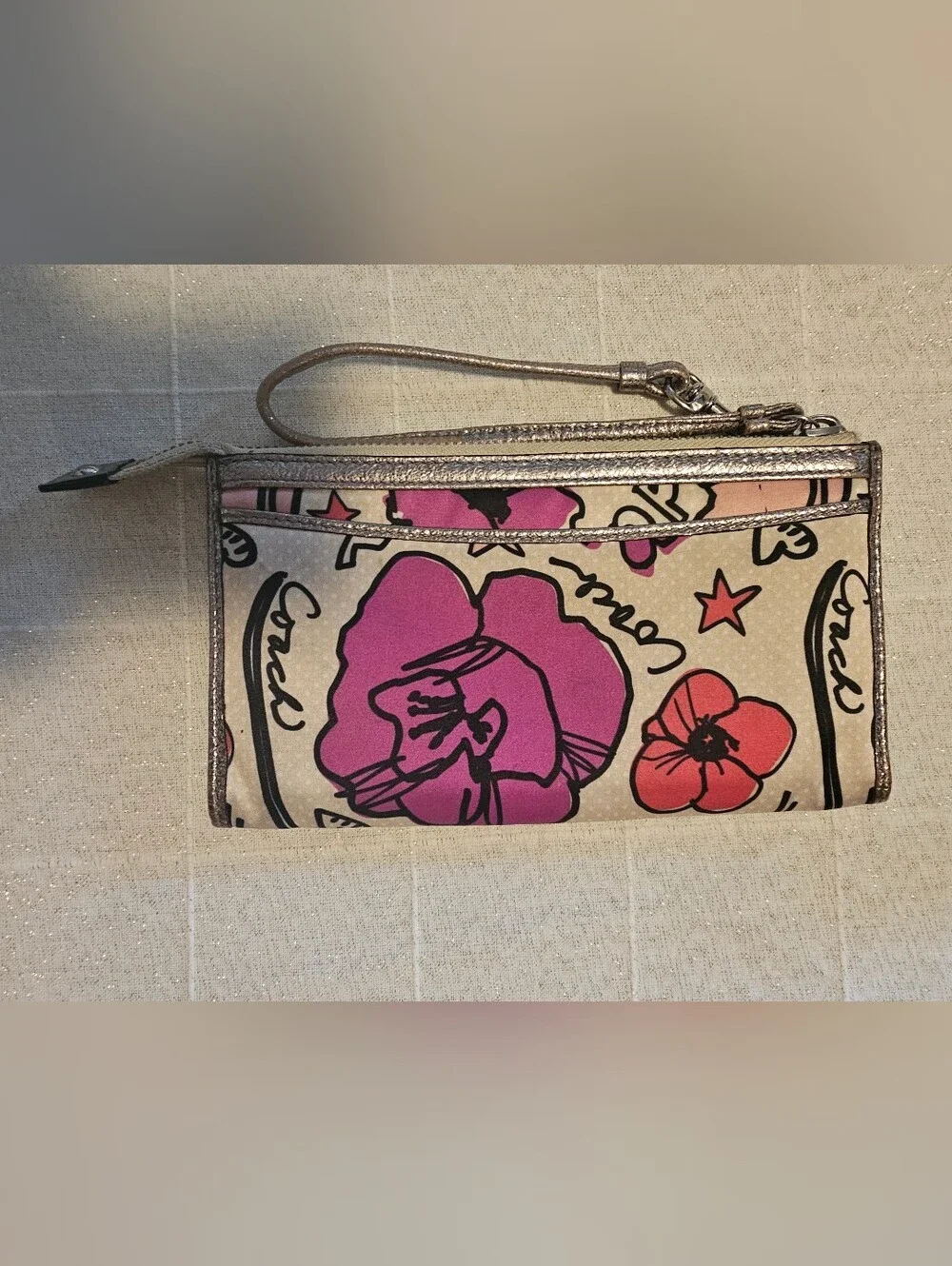 Coach Poppy pink floral graffiti print and metallic silver trim wristlet